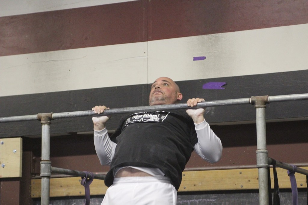 Ron demonstrating a chest to bar pull up!